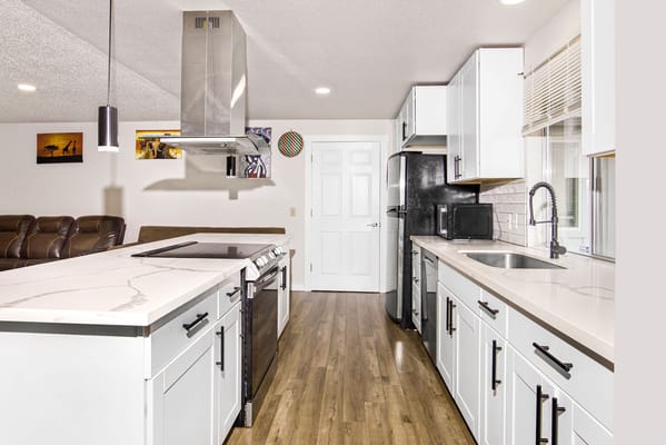 Modern kitchen with white cabinets and stainless steel appliances