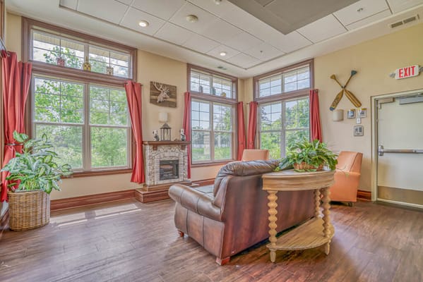 Bright common area with large windows and comfortable seating