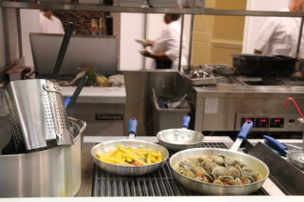 Kitchen preparation area with dishes being cooked