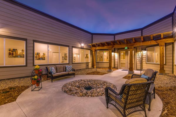 A serene outdoor seating area with chairs and landscaping