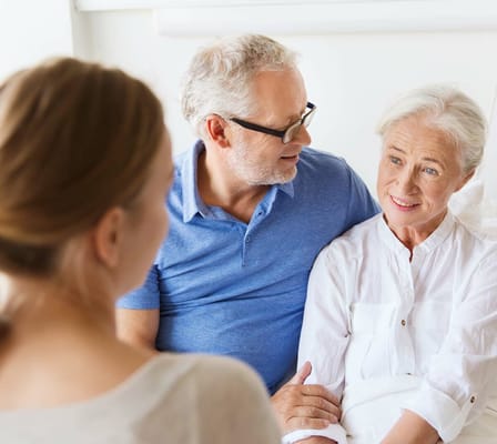 Residents interacting with staff in a cozy interior setting