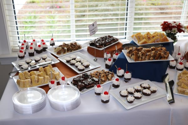 Dessert spread at a community event with cakes and pastries