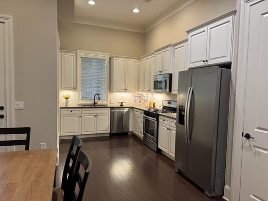 Modern kitchen interior with appliances and dining table