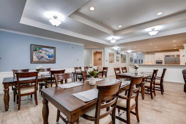 Dining area with tables and chairs in a bright setting