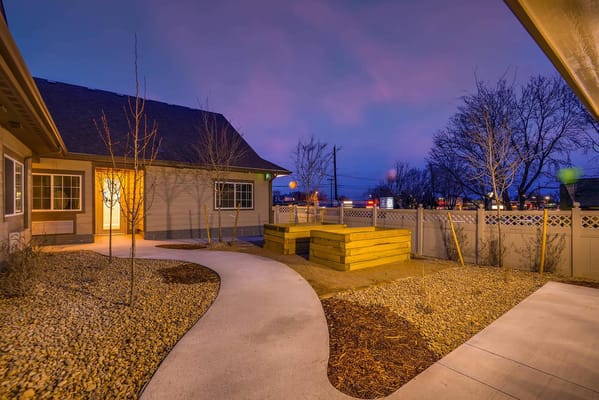 Well-lit garden path leading to the facility