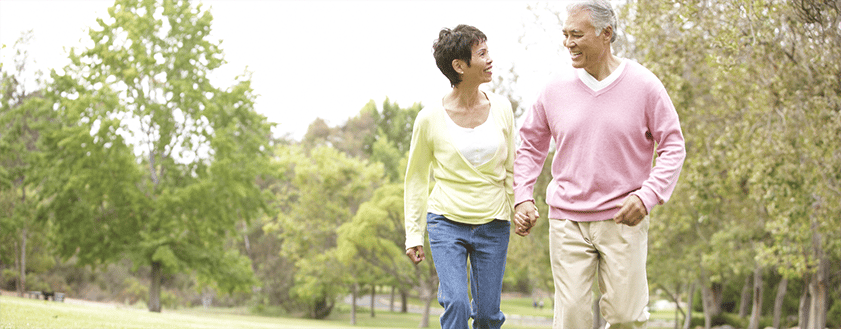 Couple walking hand in hand in a park