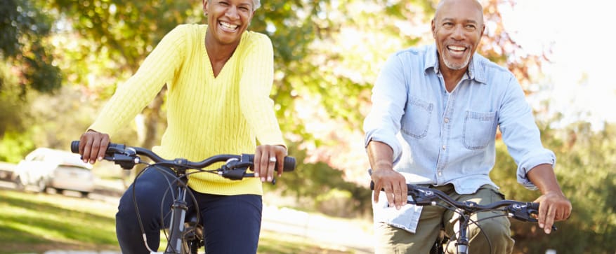 Couple enjoying a bike ride in a park