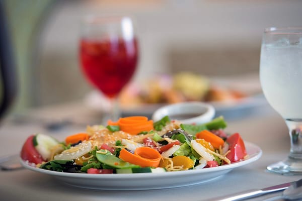 A colorful salad served at a dining room table