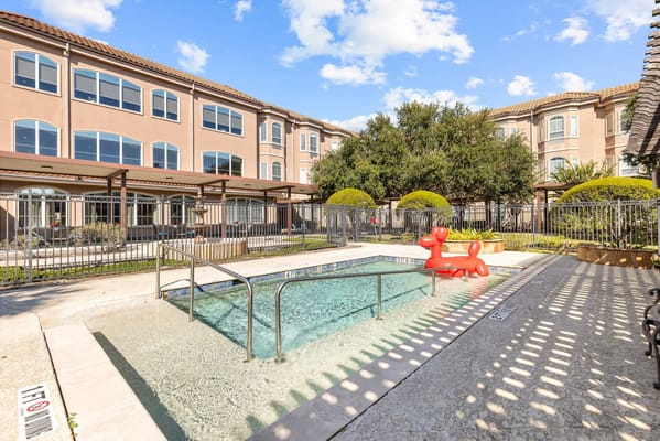 Outdoor pool area with landscaped surroundings