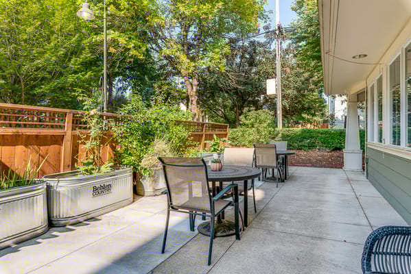 Outdoor seating area with tables and plants