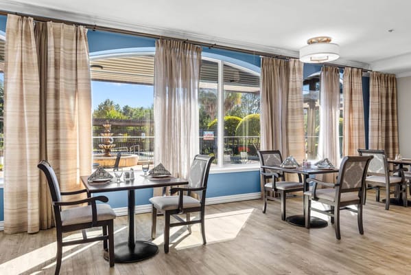 Bright dining area with tables and curtains