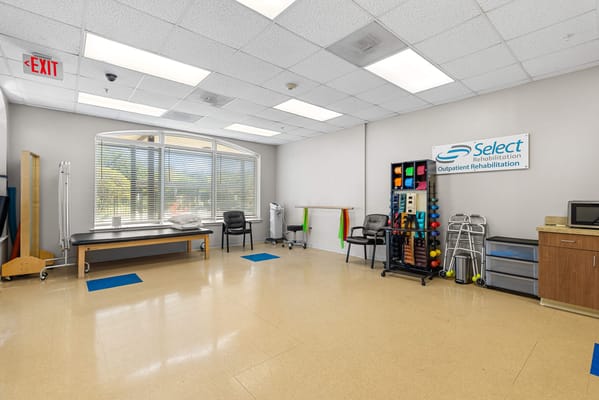 Rehabilitation room with exercise equipment and rehabilitation signage