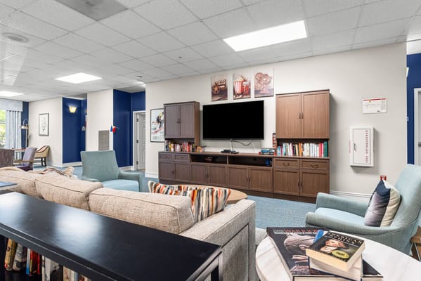 Bright common area with seating and TV