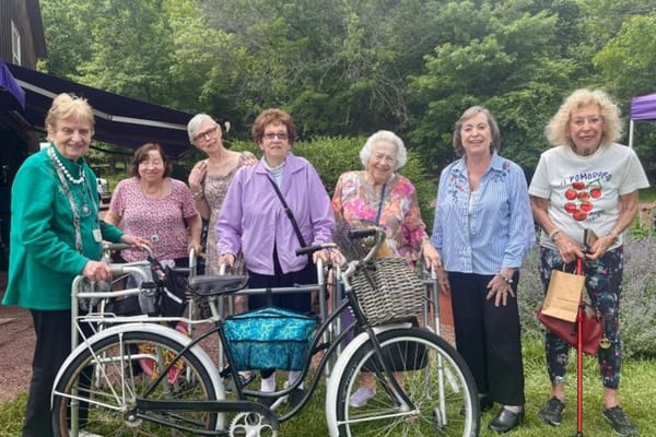 Residents enjoying outdoor activities near a bicycle