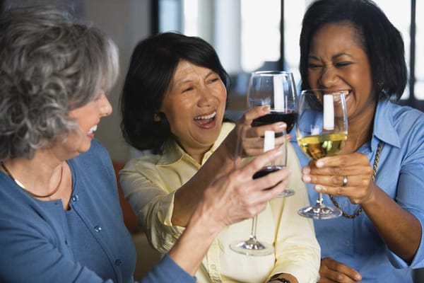 Three women toasting with glasses of wine