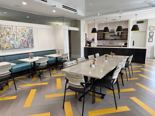 Dining area with colorful decor and flower arrangements