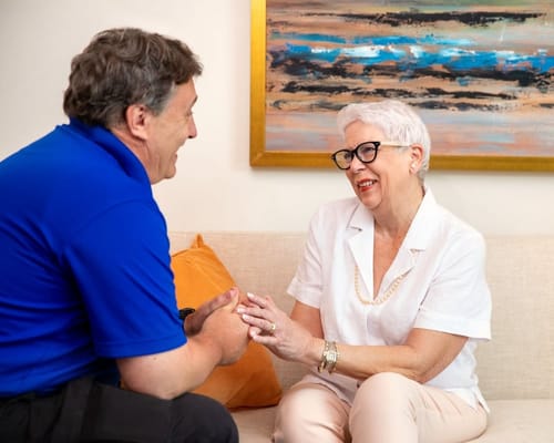 A caregiver and senior resident engaged in conversation