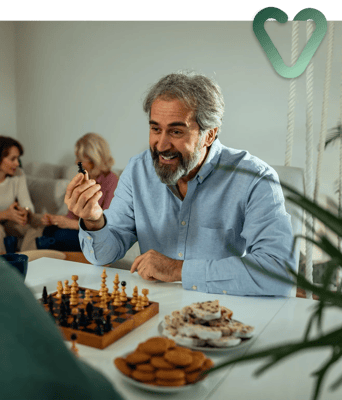 Residents enjoying a game of chess with snacks
