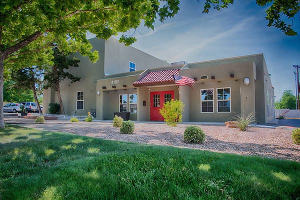 Exterior view of a senior care facility with a red door