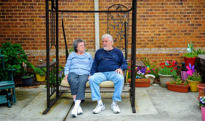 Residents enjoying time outdoors on a swing