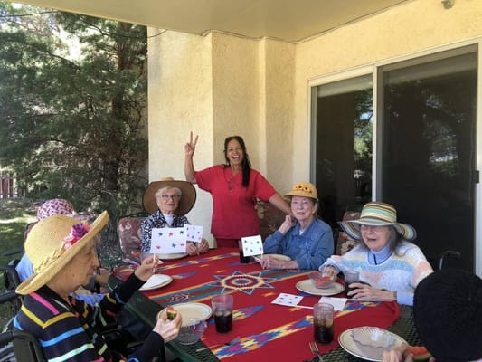 Residents engaging in an outdoor activity at a table