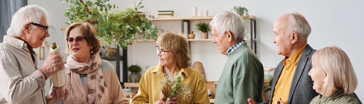 Residents and staff engaging in conversation in a common area