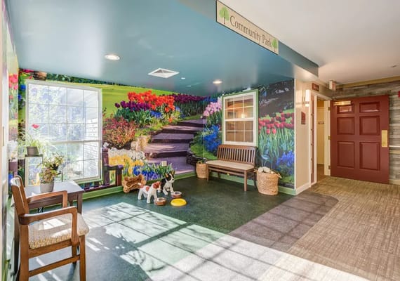 Bright hallway featuring flower mural and seating areas