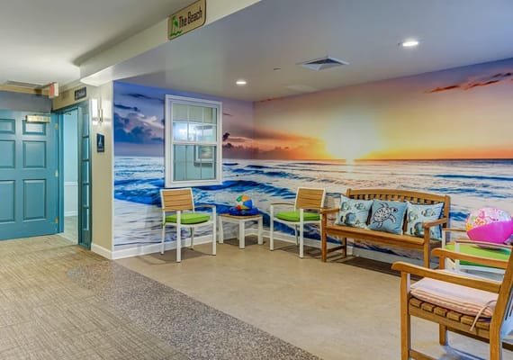 Interior common area with beach mural and seating