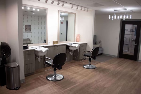 Interior view of a salon space with styling chairs and mirrors