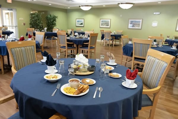 Dining room table set for a meal with various dishes