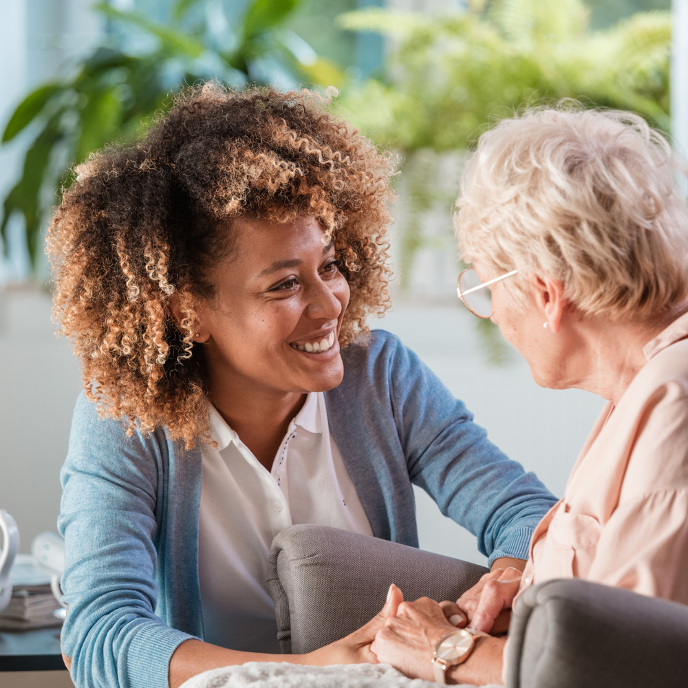 Caregiver interacting with a senior resident in a cozy setting