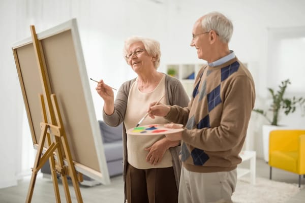 Residents enjoying a painting activity in a bright room