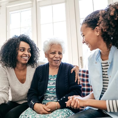 Residents and staff engaged in a friendly conversation