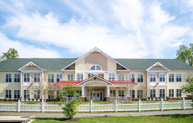 Exterior view of a senior living facility with gardens