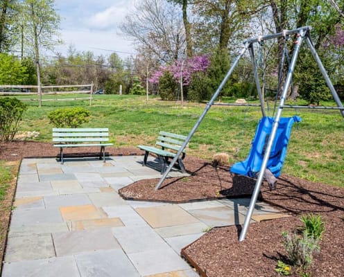 Outdoor seating area with swing in a garden