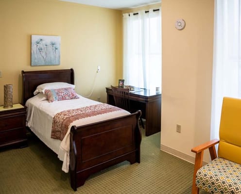 Interior view of a cozy resident room with a bed