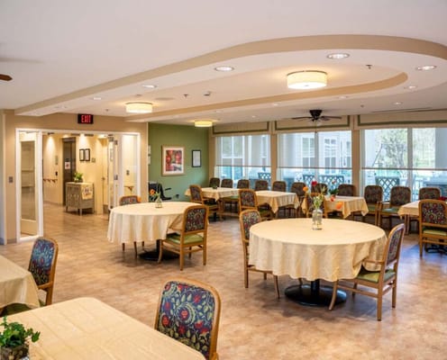 Interior view of a brightly lit common area with tables