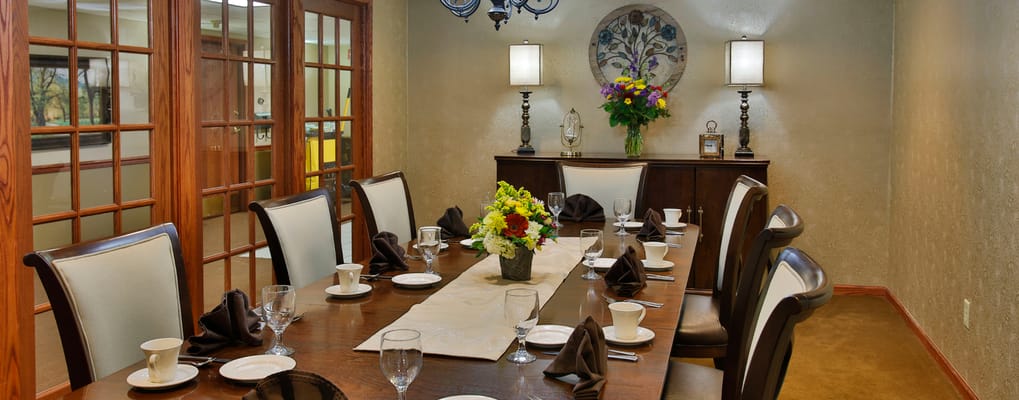 Dining room set for a meal with floral centerpiece