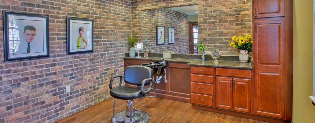 Interior view of a salon area with brick walls