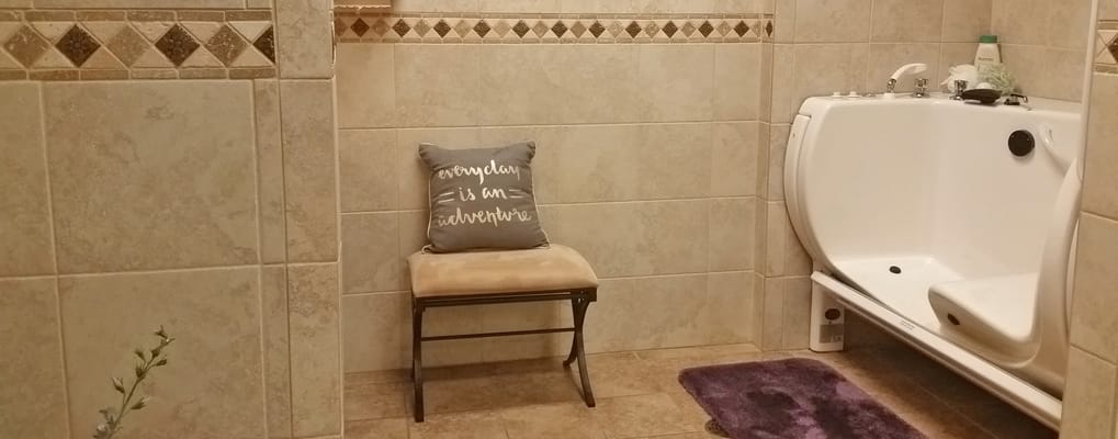 Accessible bathing area with a supportive chair