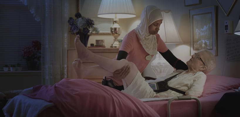 Caregiver assisting a resident in a personal room