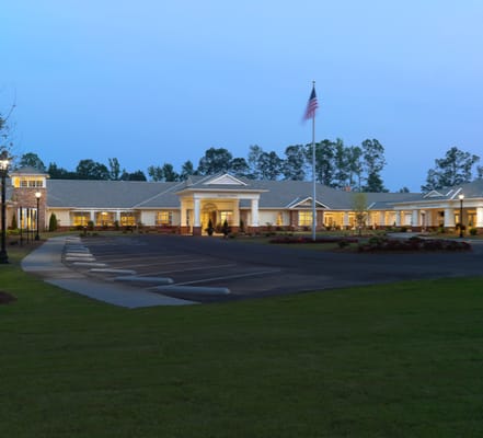 Exterior view of a senior living facility at dusk