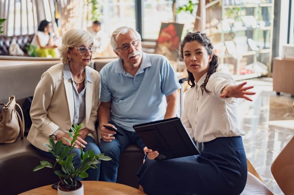 Staff member discussing with senior residents in a common area