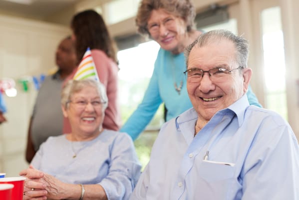 Residents enjoying a celebration with party hats