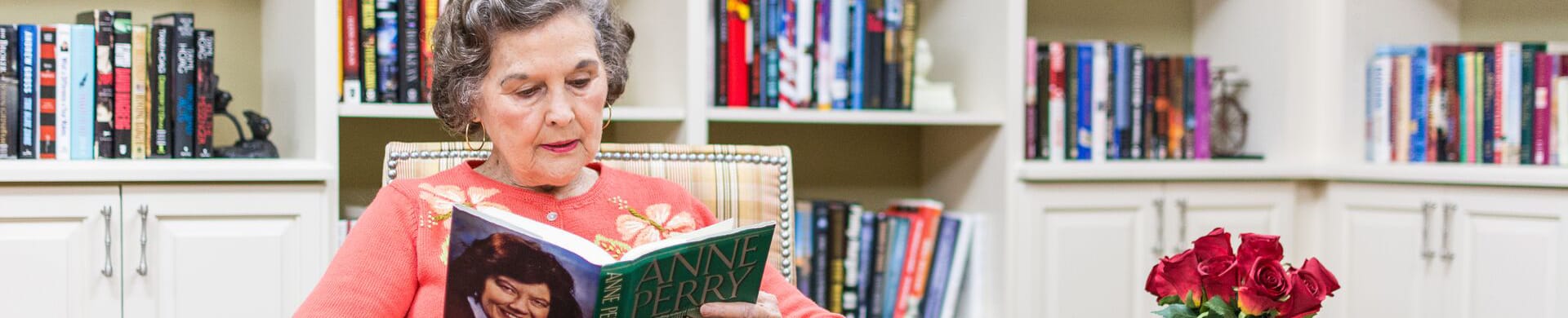 Resident reading a book in a cozy library