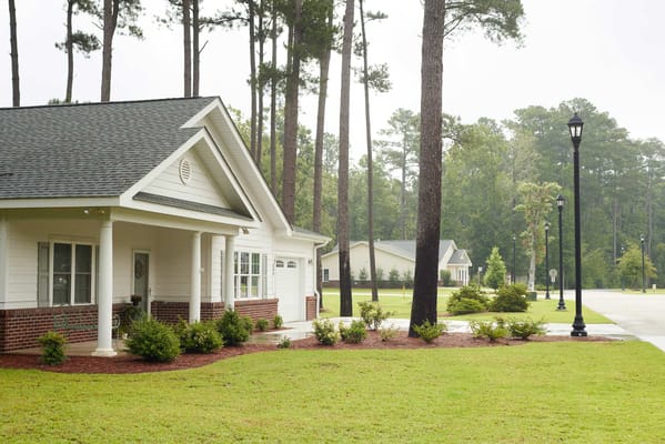 Exterior view of a nursing home building and landscaped area