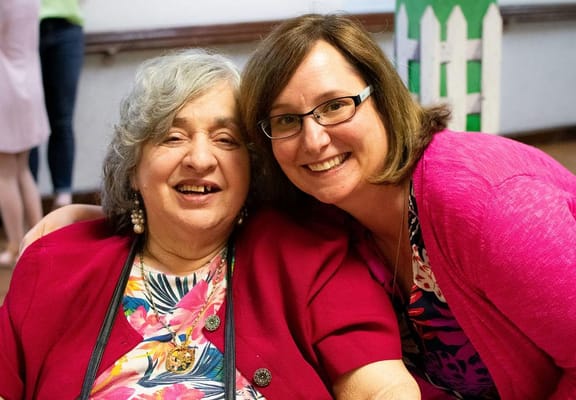 Two women smiling together in a close-up photo