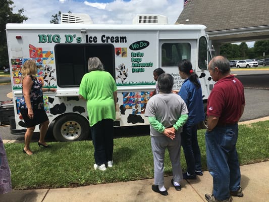 Residents enjoying ice cream from a food truck