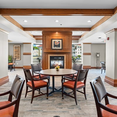 Cozy common area with seating around a fireplace