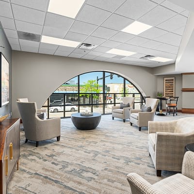 Bright common area with seating and large windows